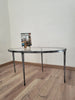coffee table made in metal with black and silver antique finish with tapered legs. Fitted with a glass top 